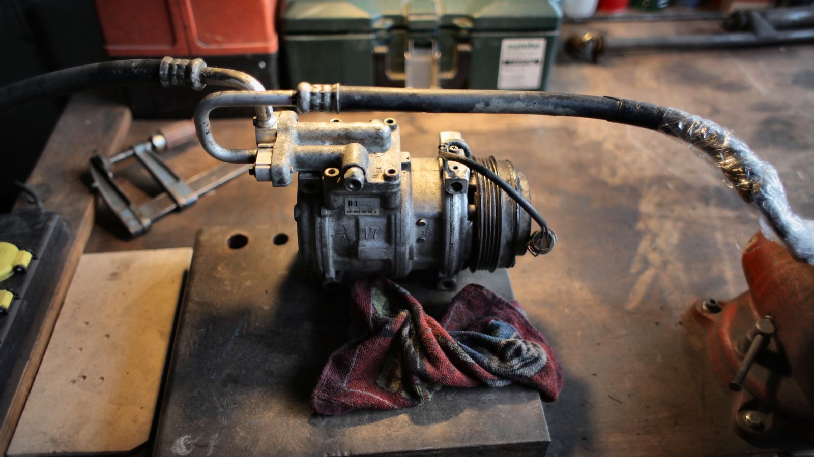 Automotive air conditioning compressor on a technical workbench